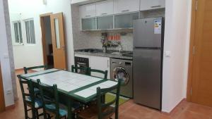 Il comprend une cuisine équipée d'une table et d'un réfrigérateur. dans l'établissement Résidence Bab Sebta, à Fnideq