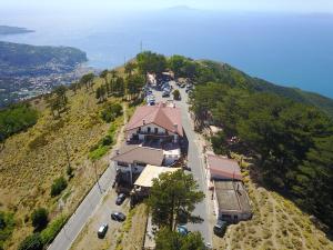 una casa en una colina con coches aparcados en una carretera en Hotel Sant'Angelo Al Belvedere, en Vico Equense