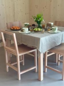 a table with two chairs and a table with food on it at B&B La Mugletta in Feriole