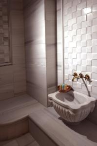 a bathroom with a sink and a shower at Darussaade Hotel Old City - Sultanahmet in Istanbul +71 photos