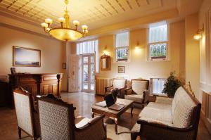 a living room with chairs and a chandelier at Darussaade Hotel Old City - Sultanahmet in Istanbul