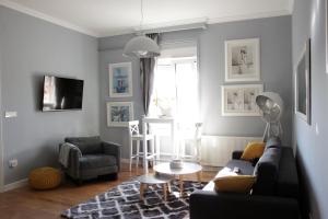 a living room with a couch and a table at Apartments O la la in Zagreb