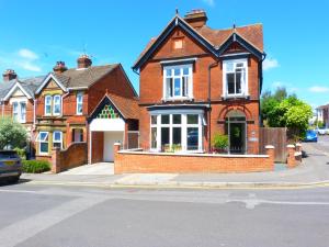 a red brick house on the corner of a street at The Old Rectory B&B in Salisbury