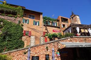 a group of buildings next to a building at La Dame Au Balcon in Roussillon
