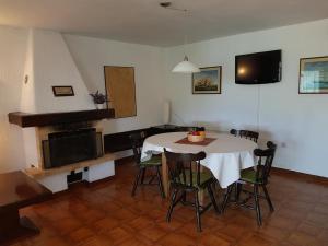 a dining room with a table and a fireplace at Sea-esta 1 in Valun