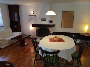 a living room with a table with a bowl of fruit on it at Sea-esta 1 in Valun +21 photos