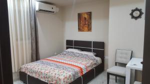 a bedroom with a bed and a chair at Studio apartman - Centar in Tivat