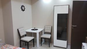 a room with a table and two chairs and a mirror at Studio apartman - Centar in Tivat