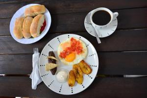 two plates of breakfast food and a cup of coffee at Feathers Hotel & Lounge in Antigua Guatemala