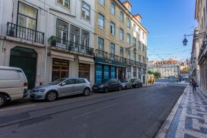 a row of cars parked on a city street at Baixa Modern Three-Bedroom Apartment - by LU Holidays in Lisbon