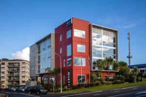 a red building on the side of a street at Quest Henderson Serviced Apartments in Auckland