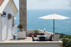 a patio with a table and an umbrella at Apartments Hollaj in Ulcinj