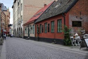 una strada acciottolata in una città con edifici di Hotell Oskar a Lund