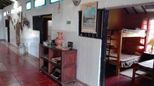 a room with two bunk beds and a table at Finca Saron Hostería & Spa in Sogamoso