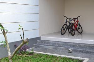 two bikes parked on the side of a house at Sakha House in Ubud