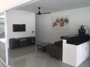 a living room with a couch and a flat screen tv at Villa MAORA 3 Bedrooms with Private Pool in Lamai