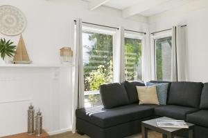 a living room with a couch and a window at Mysa Anglesea Sleeps 7 WiFi SmartTV Cafes Shops in Anglesea