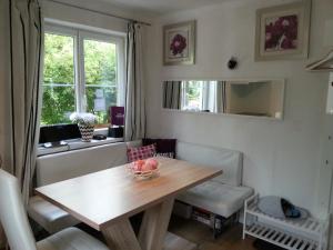 a dining room table with a bowl of fruit on it at Schafberg Apartments in St. Wolfgang