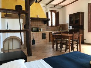 a kitchen and dining room with a table and chairs at Villa del Nespolo in Fiumefreddo di Sicilia