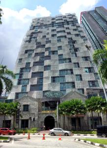 a large building with cars parked in front of it at 2Stories Empire Duplex at Damansara Perdana in Damansara Perdana
