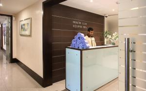 a man sitting at a counter in a lobby at The Eclipse Boutique Suites in Abu Dhabi