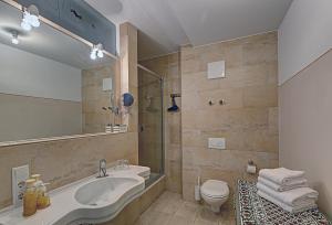 a bathroom with a sink and a shower and a toilet at Hotel Orphée - Großes Haus in Regensburg +54 photos