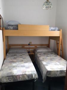 Postel nebo postele na pokoji v ubytování Pinus Village - Da Nonna Luisa