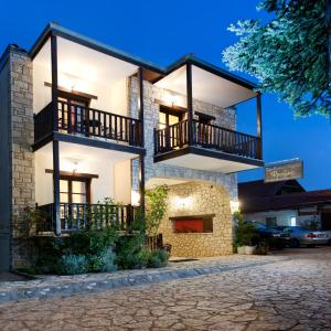 a house with two balconies on top of it at Fretzato in Elati