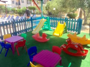 a playground with colorful tables and chairs and a slide at Carina Hotel Apartments in Ayia Napa