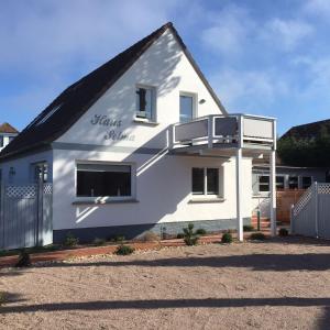 a white house with a black roof at Haus Selma in Zingst