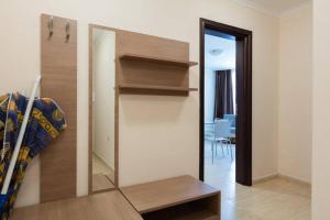 a room with a wall with a shelf and a mirror at Apartment in Luxury Resort Sveti Vlas in Sveti Vlas