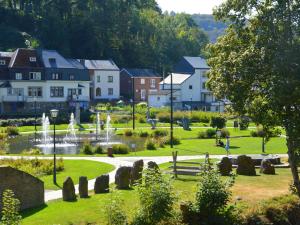 a park with a fountain in the middle of a town at Cozy Family Holiday Home in La Roche-en-Ardenne