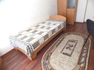 a bedroom with two beds and a rug at Elektromash Hotel in Tiraspol