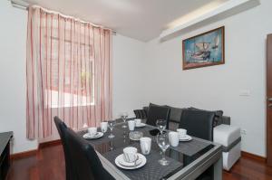 a dining room with a table and chairs and a window at Split Center Apartment in Split