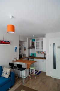 a kitchen with a blue couch and a table at Dalgaci Deniz Konukevi in Ayvalık