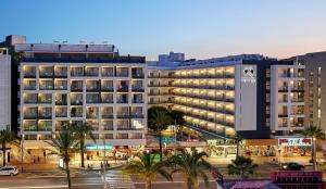 a hotel in a city with palm trees and buildings at Gran Hotel Flamingo-Adults Only older 18 years old in Lloret de Mar