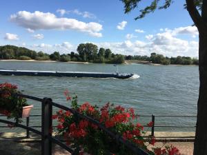 a barge is going down the river at City Apartments Will in Emmerich