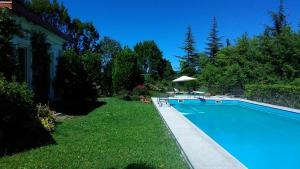 a swimming pool in the yard of a house at Villa le Noci in Bettola