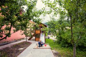 a little boy sitting on a bench in a park at Berizka in Yaremche