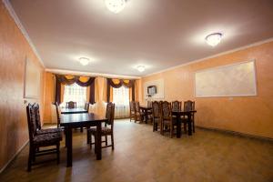 a dining room with a table and chairs at Berizka in Yaremche