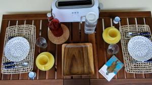 a wooden table with bowls and plates and a toaster at Riverfront studio in Lisbon