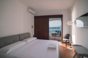 a bedroom with a bed and a view of the ocean at Villa Crawford in San Nicola Arcella