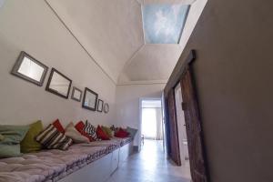 a room with a long couch with pillows on it at Casatorre dei Leoni Dimora Storica in Siena