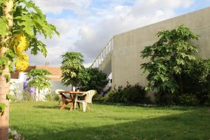 a table and chairs in a yard next to a building at Prem Home Stay in Khajurāho