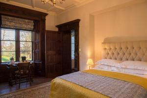 Hall Bed & Breakfast في Bishops Tawton: غرفة نوم بسرير ومكتب ونافذة