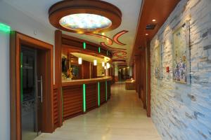 a corridor of a restaurant with a large ceiling at Spa Hotel Armira in Starozagorski Bani