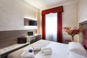 Postel nebo postele na pokoji v ubytování Hotel Gamma