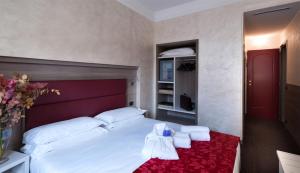 Postel nebo postele na pokoji v ubytování Hotel Gamma