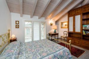 a bedroom with a bed and a book shelf at Mansarda Lina in Casarza Ligure +136 photos