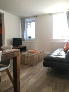 a living room with a couch and a coffee table at Moserhof-Apartments in Igersheim